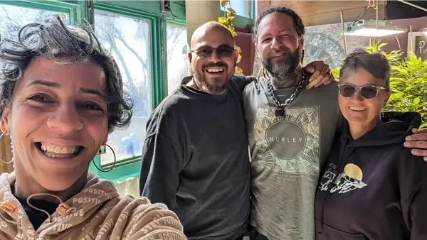 Guests smiling during a guided tour at Earthship Journey